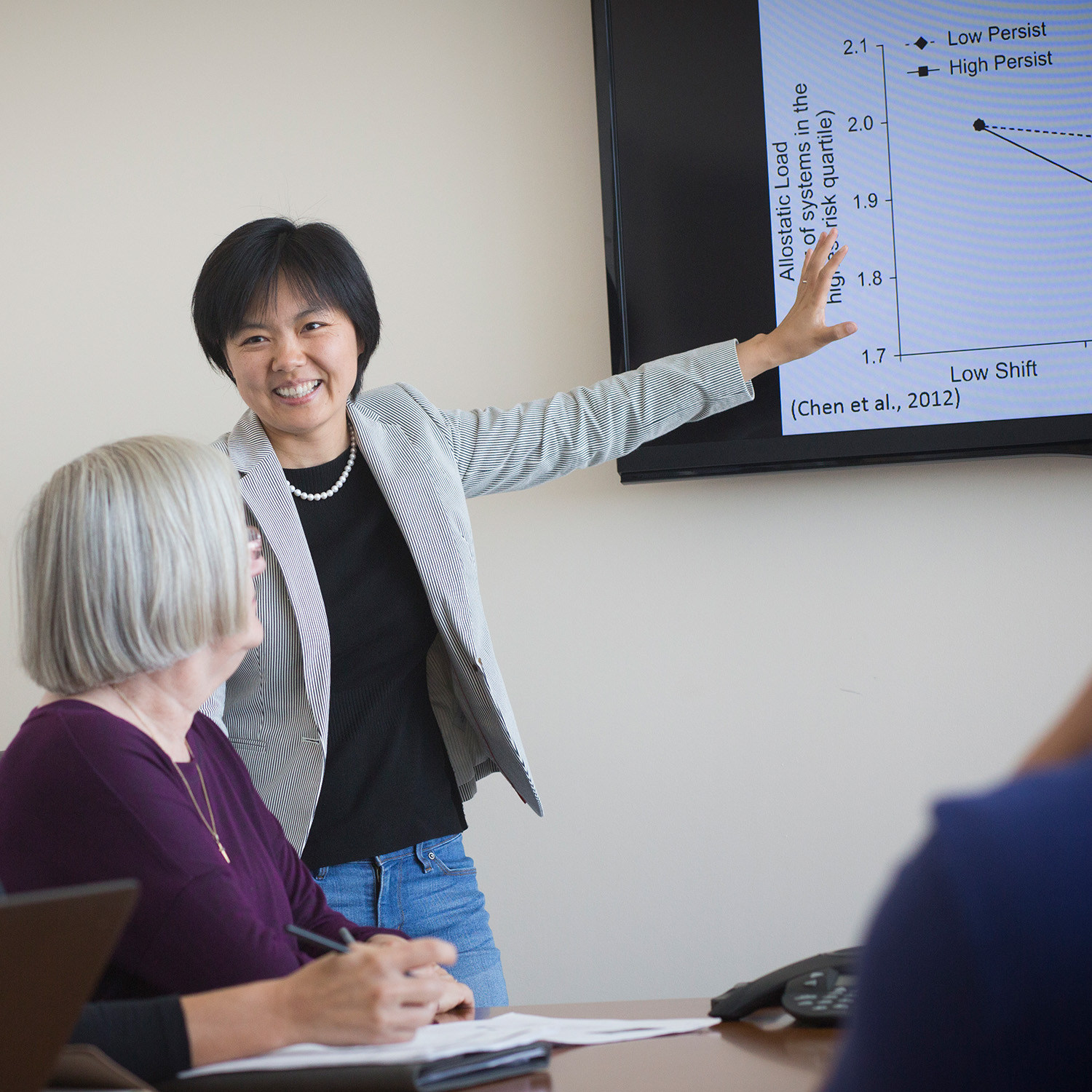 An instructor points to a chart on the screen.