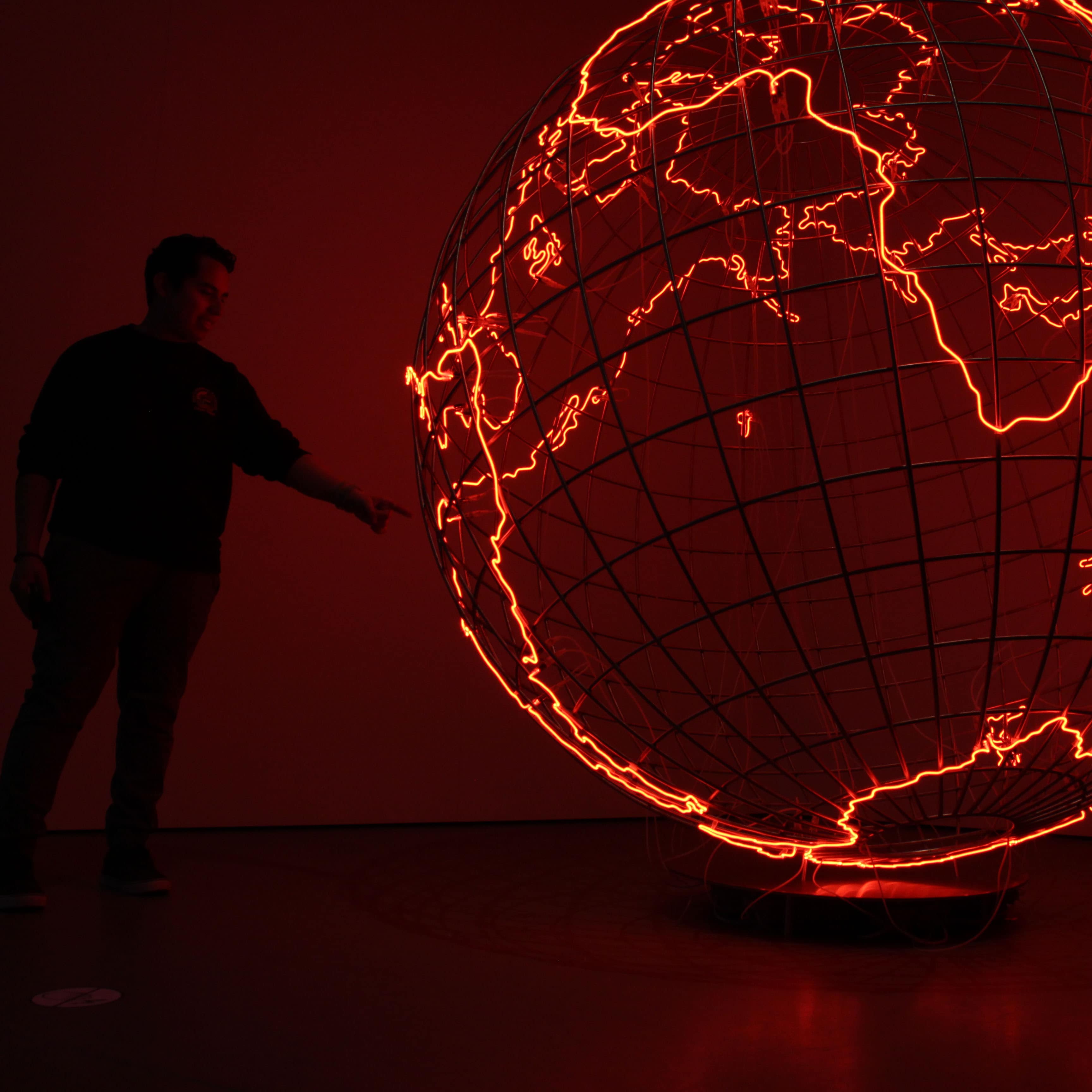 guy looking at a globe