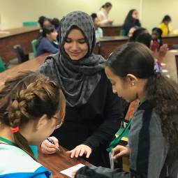 international student speaking to middle school students