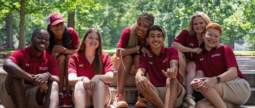 Orientation Leaders smiling and posing for a photo on the Horseshoe