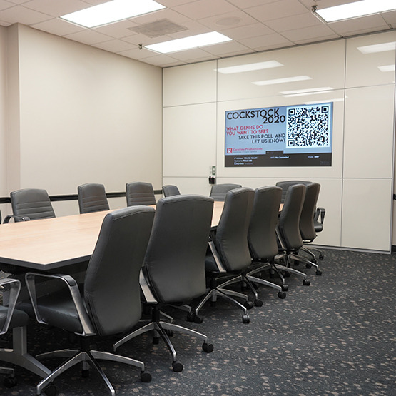 meeting room with lots of windows and a big screen for presentations