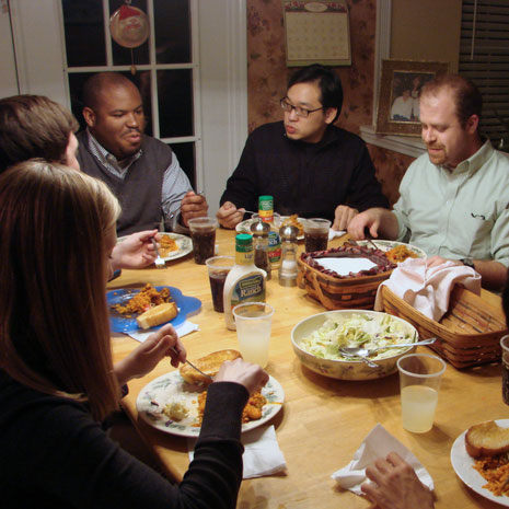 students and instructor eating dinner