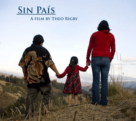 A refugee family holding hands, standing on a mountain