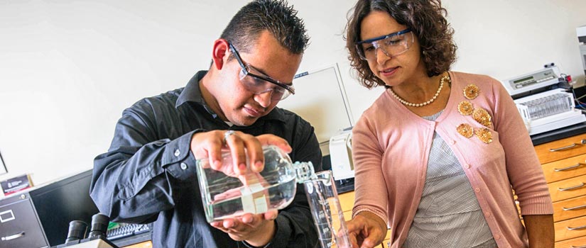 Professor Obi-Johnson instructs a student in a lab