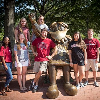 Group of students gathered around the Cocky Statue.