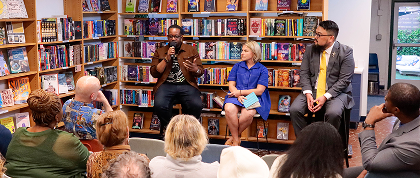 Photo of Seulghee Lee speaking to a crowed at the book launch for Seulghee Lee, Leah McClimans, and Jabari Evans