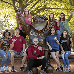 students by cocky statue