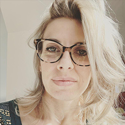 woman with blonde hair and glasses on