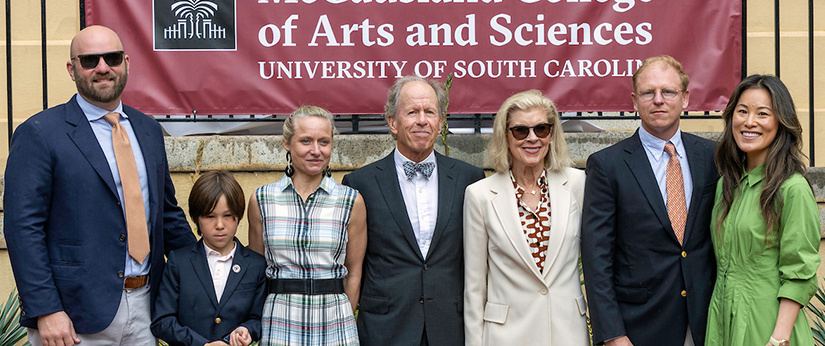 Peter and Bonnie McCausland stand beside a new McCausland College of Arts and Sciences display on the University of South Carolina Horseshoe during the naming ceremony.