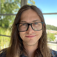 photo of a man in blue shirt with glasses