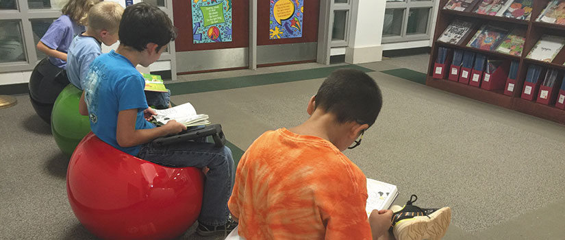 Young students reading in the library.