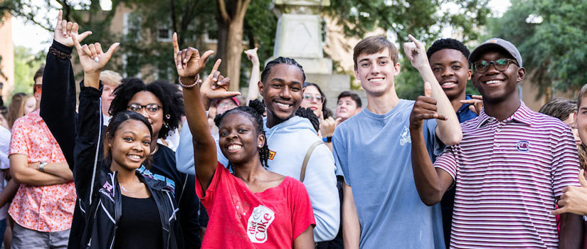 group of students giving "Spurs Up" sign.