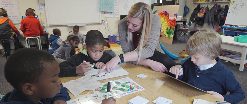 A female teacher in a busy classroom