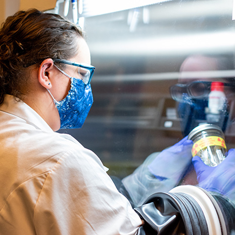 woman works in a hood in the lab