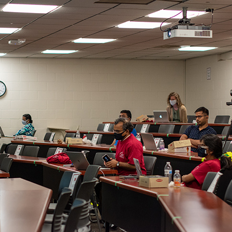 professors watch a presentation in a classroom