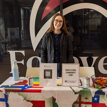 A member of the HRSM Global Community poses at a student organization fair