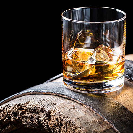 Old and tasty brendy with ice on oak barrel