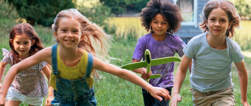 Children running with a homemade rocket