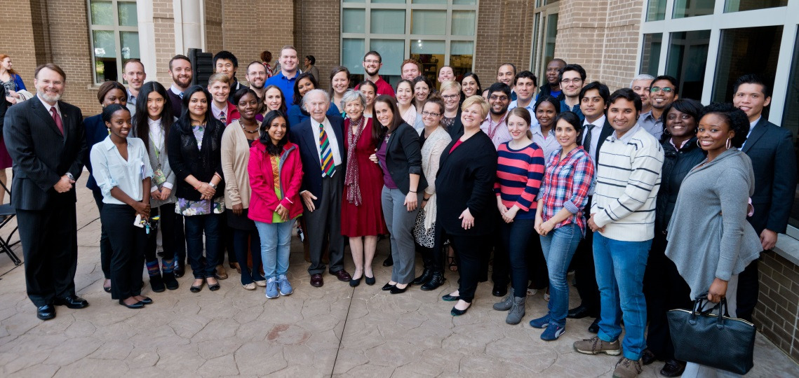 Arnold School faculty, staff, and students standing with Norman J. Arnold