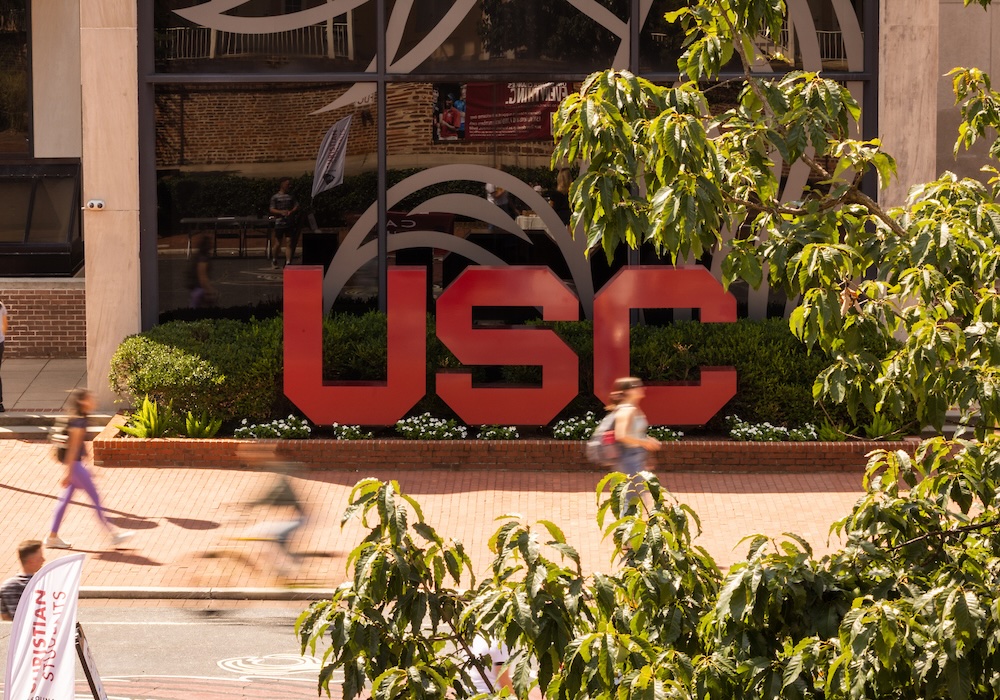 garnet block USC letters in front of Russell House