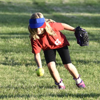 Kid playing softball on field