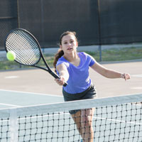 Kid playing tennis.