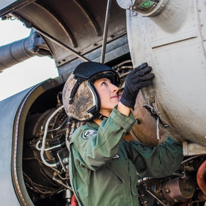 Molly O'Malley beside helicopter