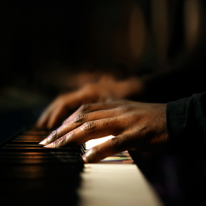 photo illustration of Black hands playing a piano