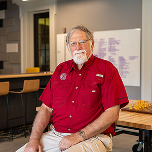 John Gerdes sits in the makerspace.