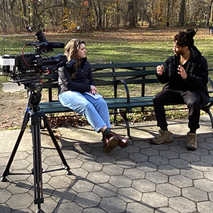 two people talking on a park bench