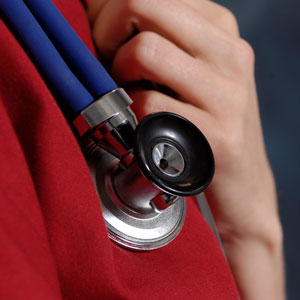 A very close shot of a USC nursing student with her hand on her stethescope.