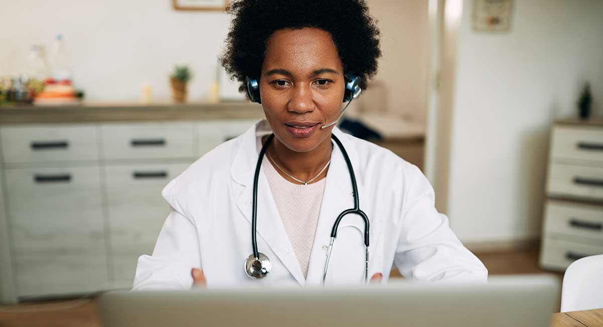 Female telehealth provider advises over a computer. 