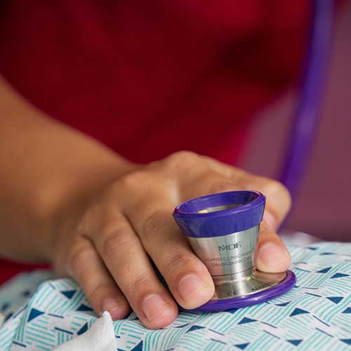 Student listens to patient's chest with a stethoscope