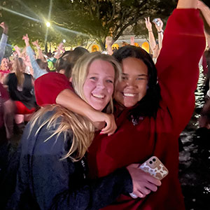 Cassidy Clark and friend celebrate in the library fountain.