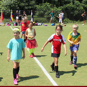 A group of young girls on a soccer field 