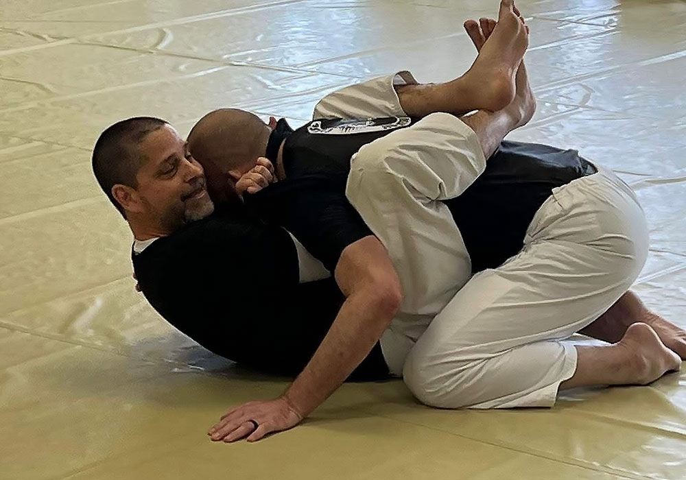 two people practicing jiu jitsu